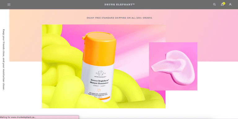 A web page with a white and yellow bottle on the left labeled "Drunk Elephant" against a yellow and pink background. On the right, a smear of pink cream is shown. The top text offers free standard shipping on all orders over $50. Discover 2024's expert resource for revolutionary skincare solutions. - Ketamine